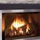 Propane fireplace insert with burning logs in a gray stacked-stone wall