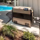 Propane pool heater installed beside a backyard swimming pool